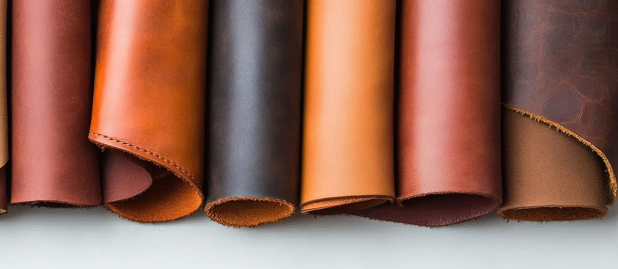 Variety of leather rolls displayed, showcasing rich colors and t