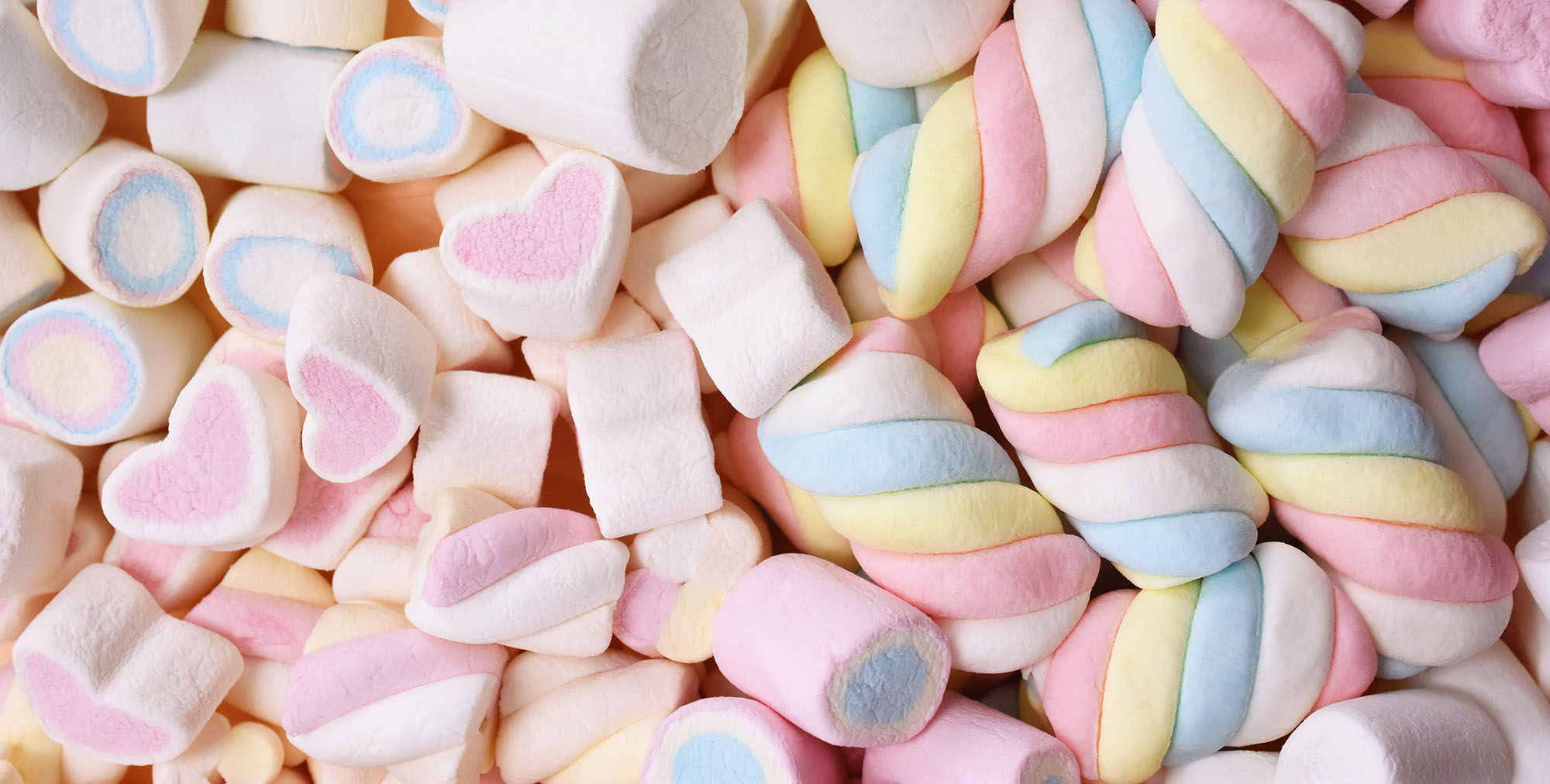 Confectionery and sweeties varieties background: light pink and